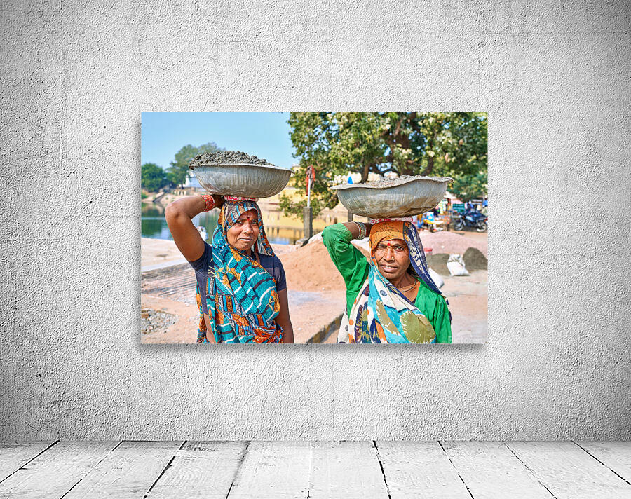 Women carry materials in Varanasi near the river bank Wall Preview