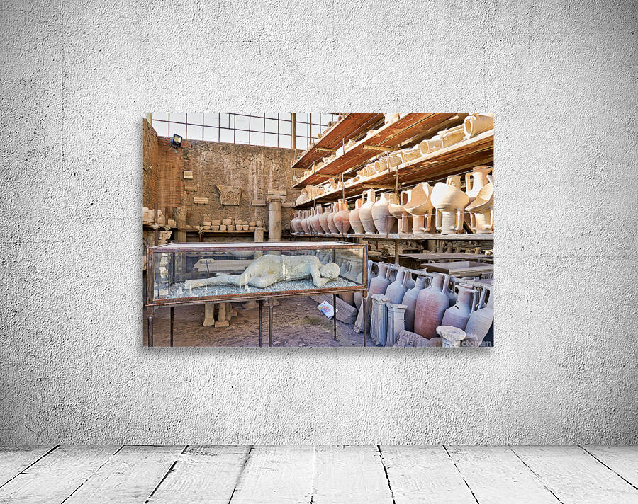 Pompeii site showing artifacts and a plaster cast of a victim Wall Preview