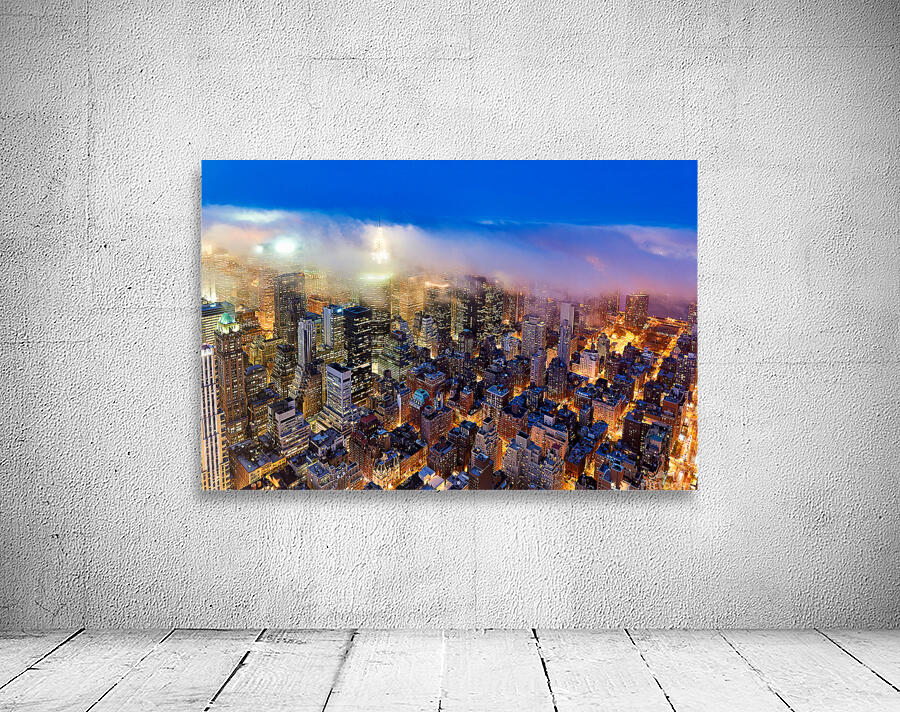 Aerial view shows Manhattan skyline at dusk with city lights Wall Preview
