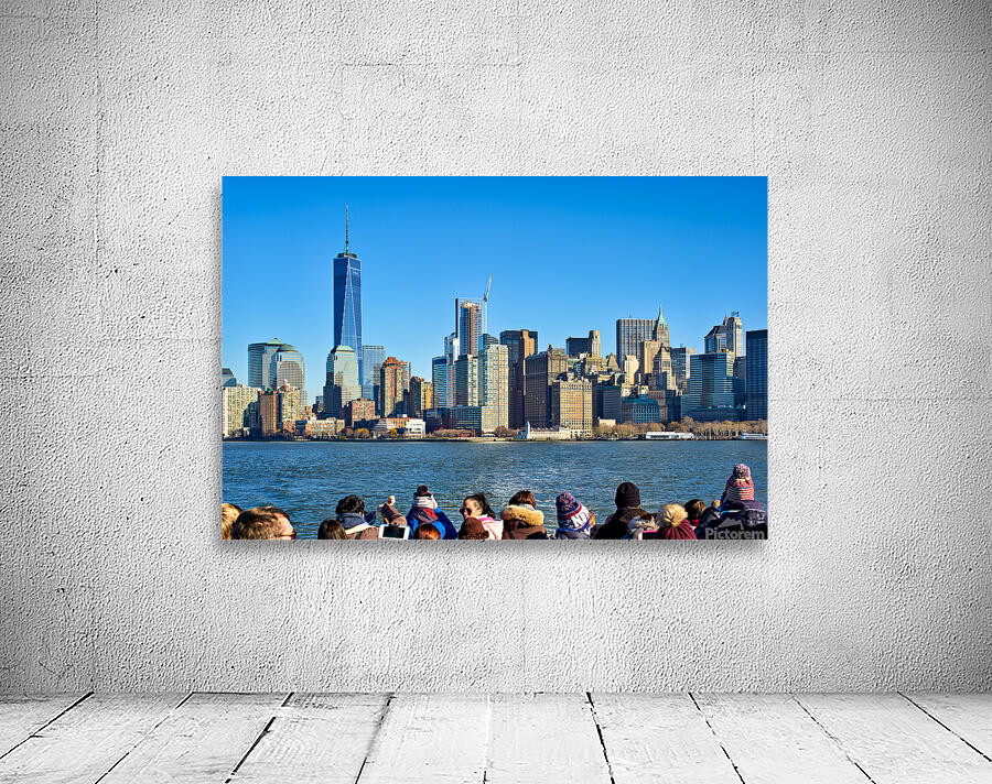 Tourists view Manhattan skyline from a boat on the water in New  Wall Preview
