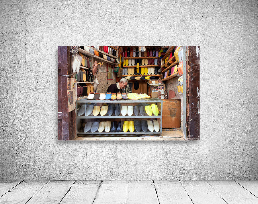 Moroccan babouches shoes in a Fez shop with a vendor Wall Preview