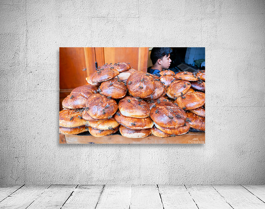 Loaf of bread covered in flies at market in Fez Morocco Wall Preview