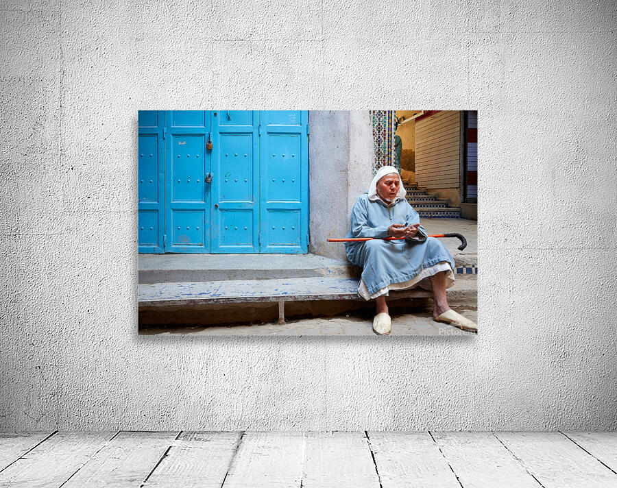 Portrait of a beggar sitting by a blue door in Fez Morocco Wall Preview