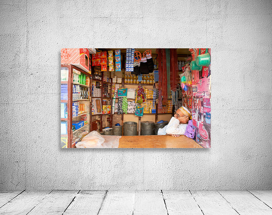 Grocer sleeping in shop in Marrakesh during afternoon hours Wall Preview