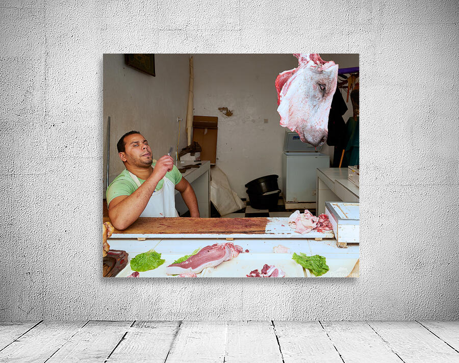 Butcher at work in Meknes souk showing fresh meat and livestock Wall Preview