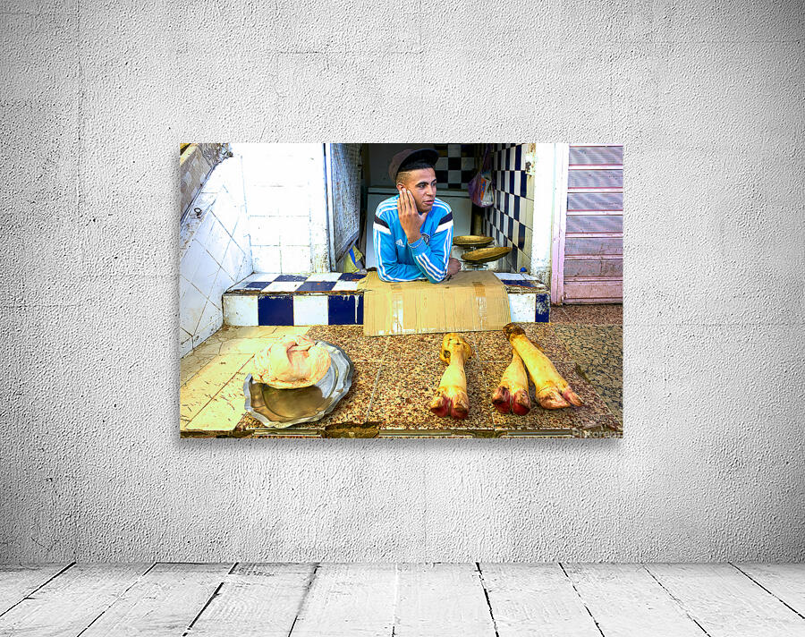 Butcher in Meknes souk interacts with customers during market ho Wall Preview