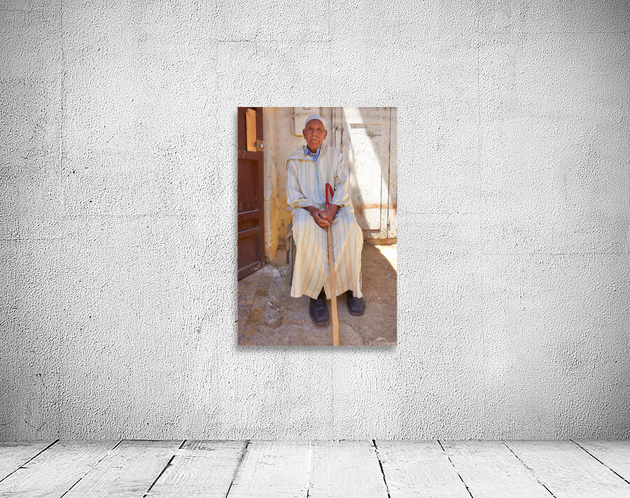 Old man sitting in Meknes Morocco in daylight Wall Preview
