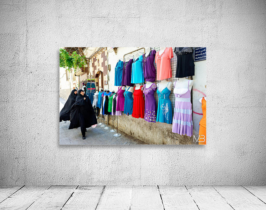 Women walk past colorful clothing displays in Damascus Syria Wall Preview