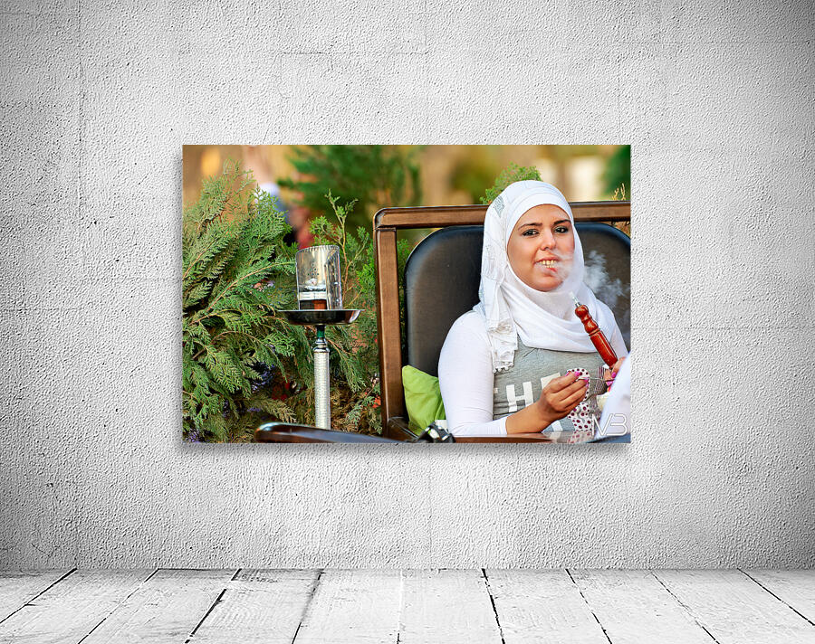 Young woman smokes hookah in outdoor cafe in Aleppo Syria Wall Preview