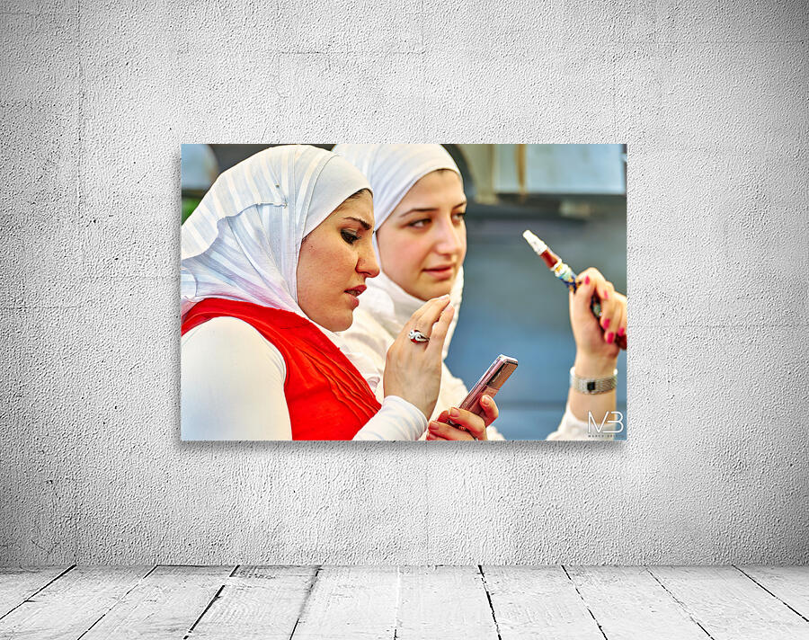 Young women enjoy hookah and talk on mobile phone in Aleppo Syri Wall Preview