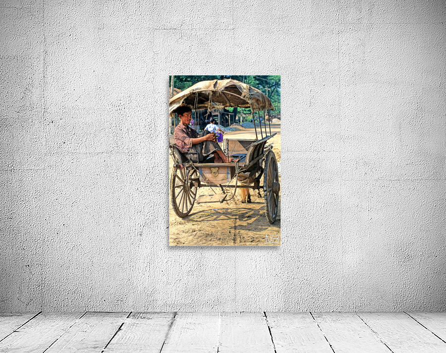 Man rests on cart in Myanmar during warm daytime Wall Preview