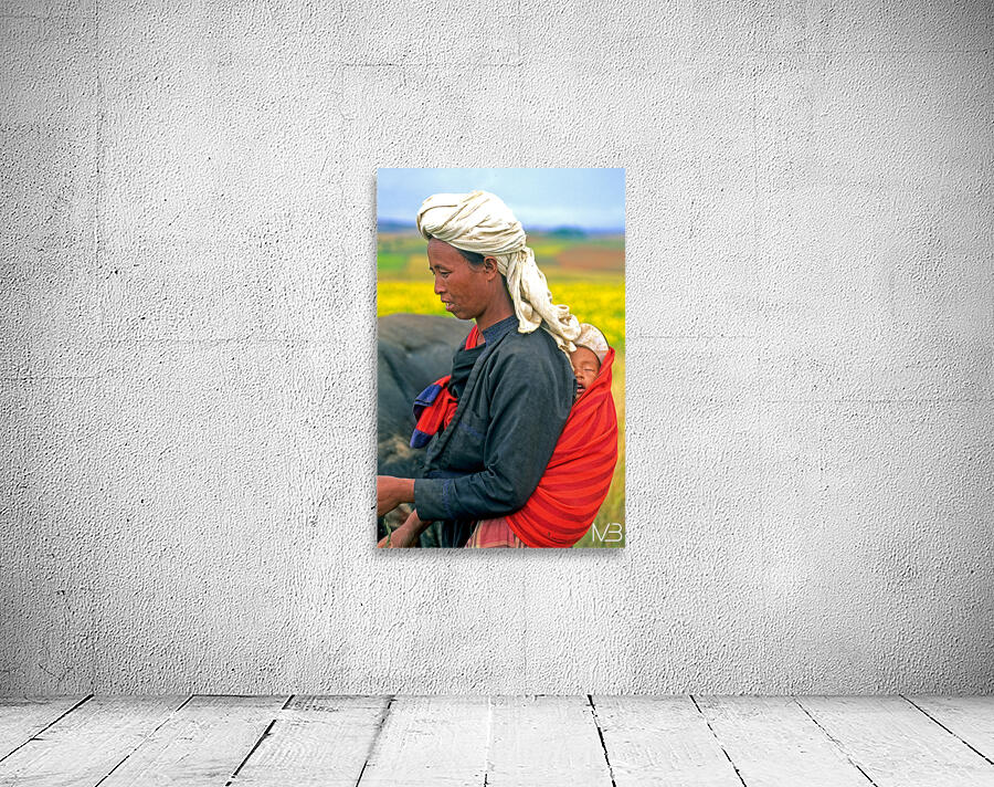 Woman carries son on her back in Myanmar fields Wall Preview