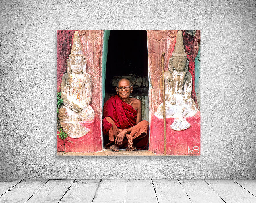 Old monk meditates in temple doorway in Myanmar Wall Preview