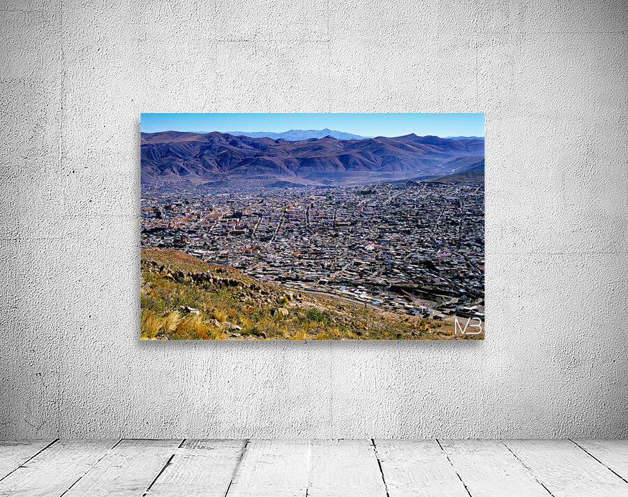 Panoramic view of a sprawling city in a mountain valley. Wall Preview