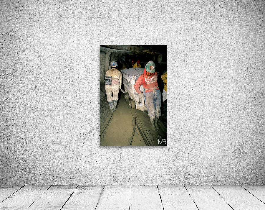 Miners pushing a loaded cart through a muddy underground mine. Wall Preview