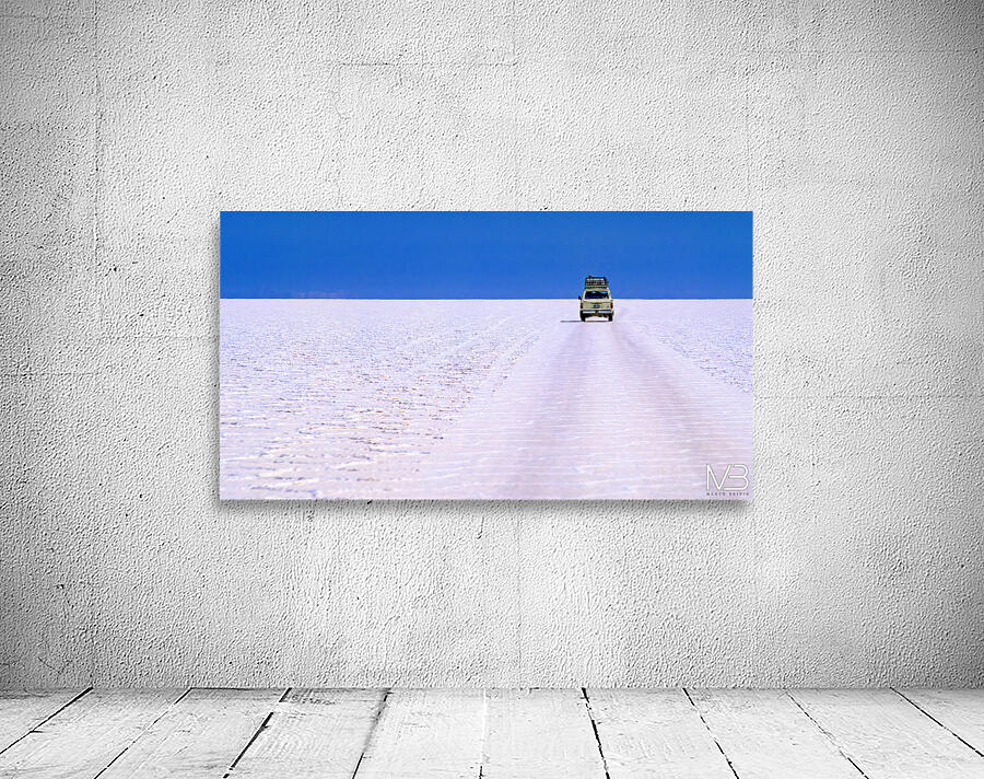 Van driving across vast white salt flat under blue sky. Wall Preview