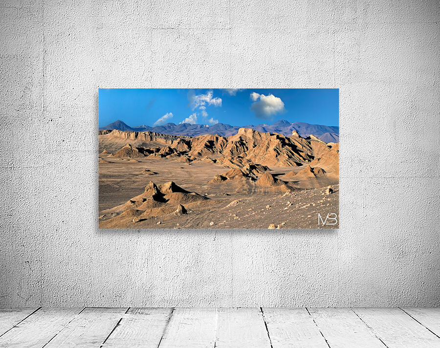 Rugged desert mountains under a clear blue sky with clouds. Wall Preview