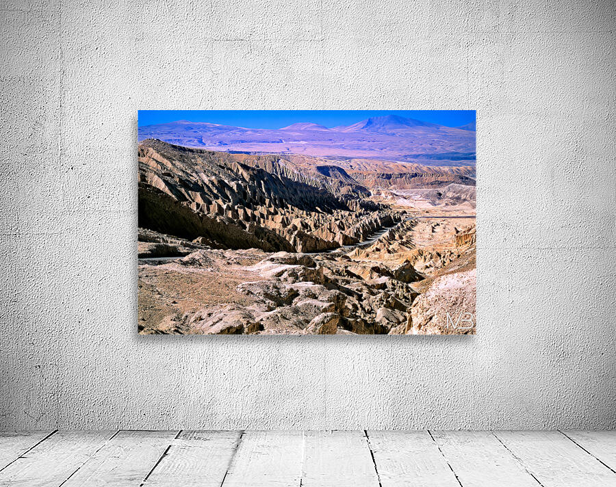 Eroded desert landscape with a road winding through mountains. Wall Preview