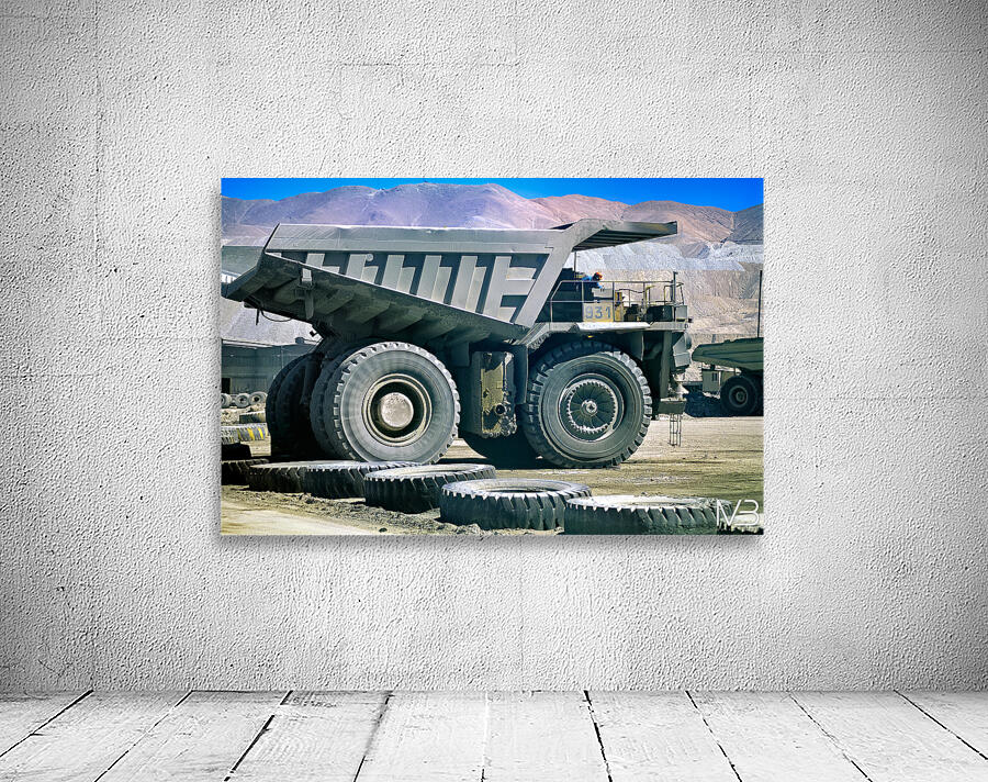Giant mining dump truck in a dusty mountain quarry. Wall Preview