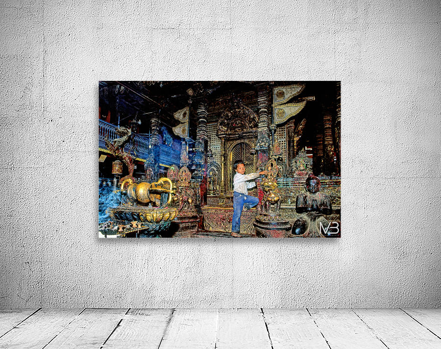 Boy interacts with religious artifacts in Kathmandu temple Wall Preview