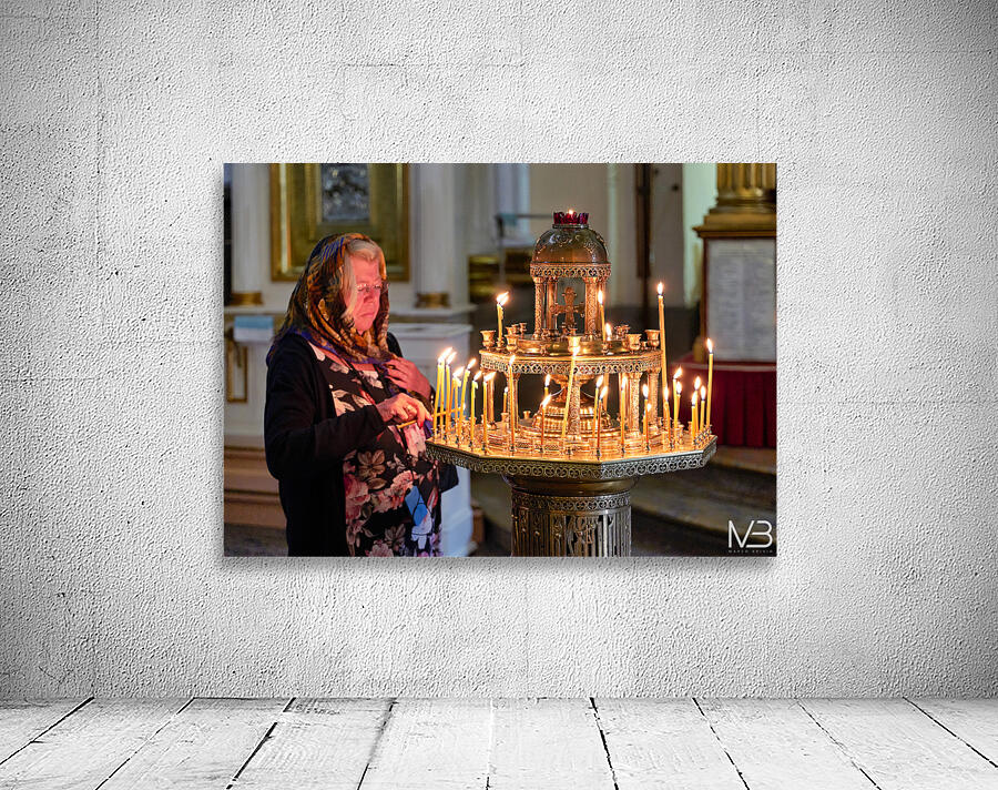 Woman lights candles at Alexander Nevsky Lavra Wall Preview