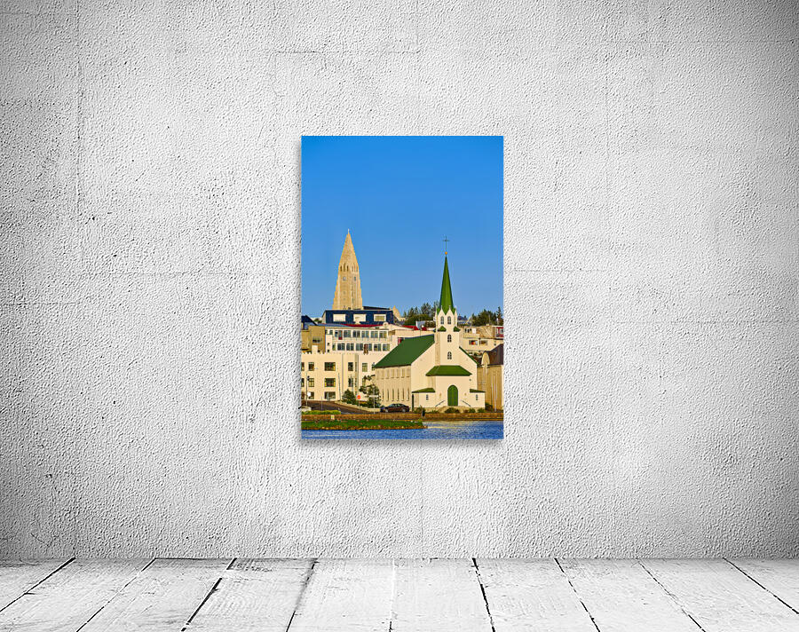 Lutheran free church by lake Tjornin and Halgrimskirkja Wall Preview