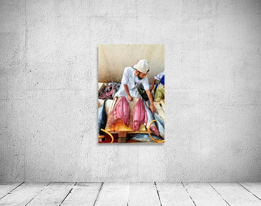 Fish market in Muscat Oman shows a vendor at work Wall Preview