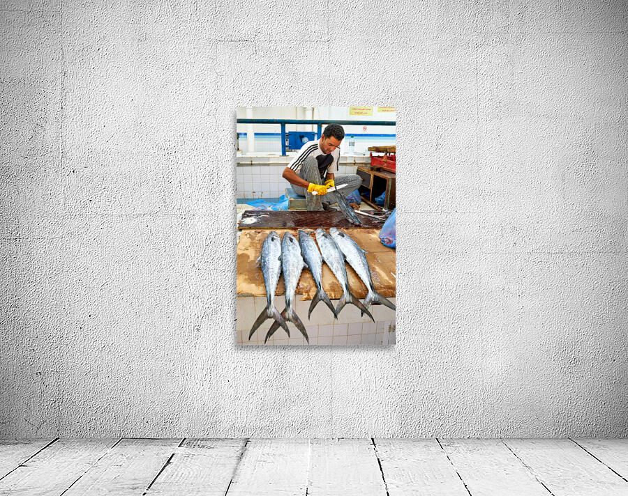 Fish seller prepares catch at Nizwa Oman fish market Wall Preview