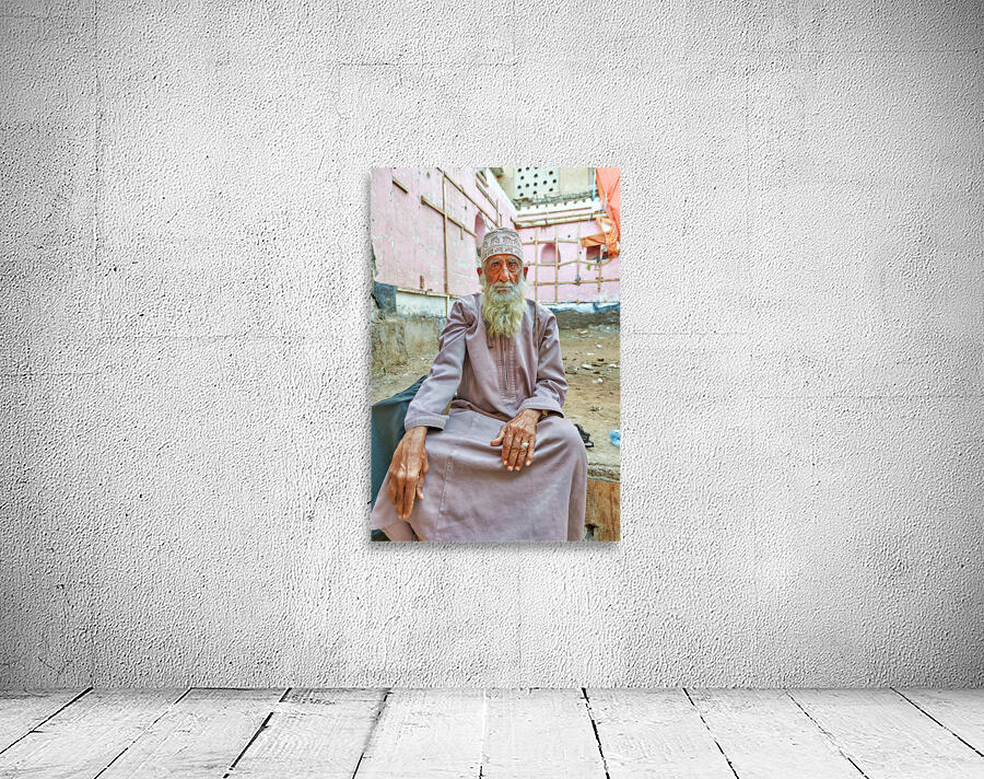 Old man sitting in a historical site in Muscat Oman Wall Preview