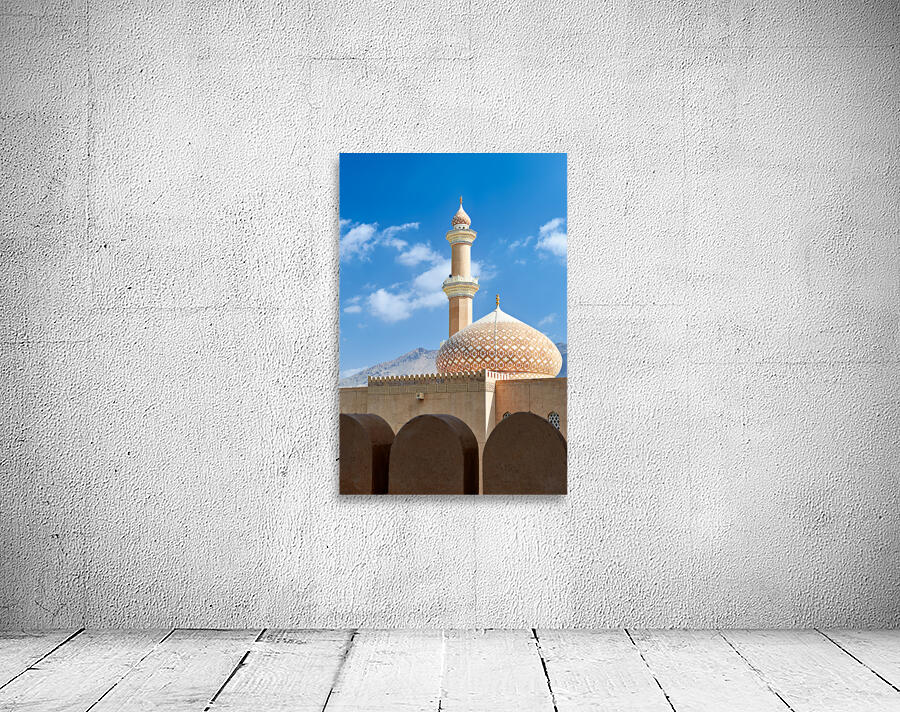 Nizwa Fort shows mosque and tower with blue sky and clouds Wall Preview