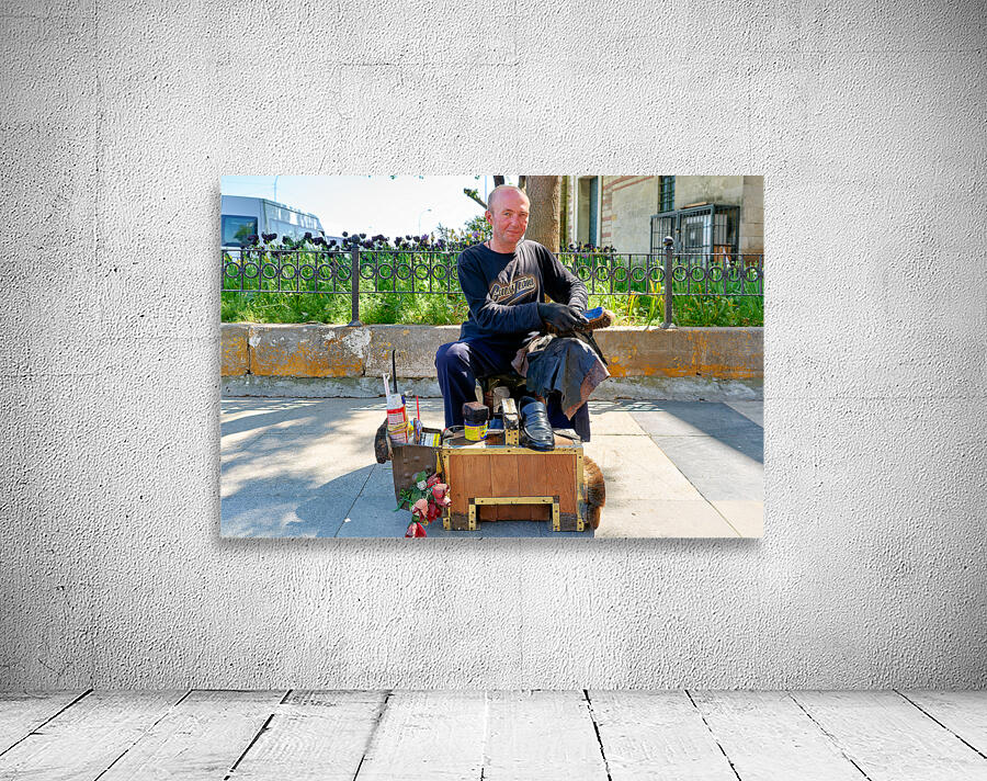 Shoeblack working on shoes in Istanbul Turkey during the day Wall Preview