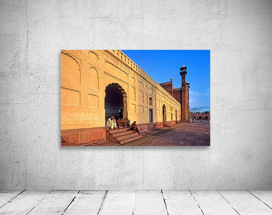 Visitors rest by Badshahi Mosque during sunset in Lahore Wall Preview