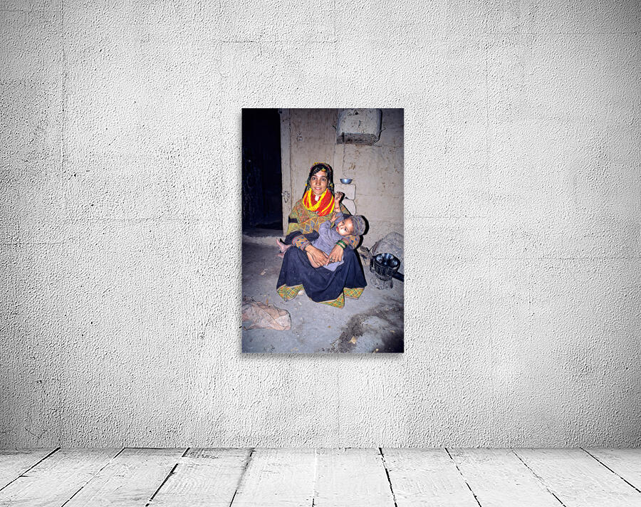 A woman holds her child in a Kalash village Wall Preview