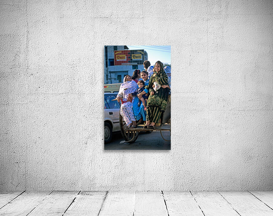 Family travels on rickshaw in busy Lahore streets Wall Preview