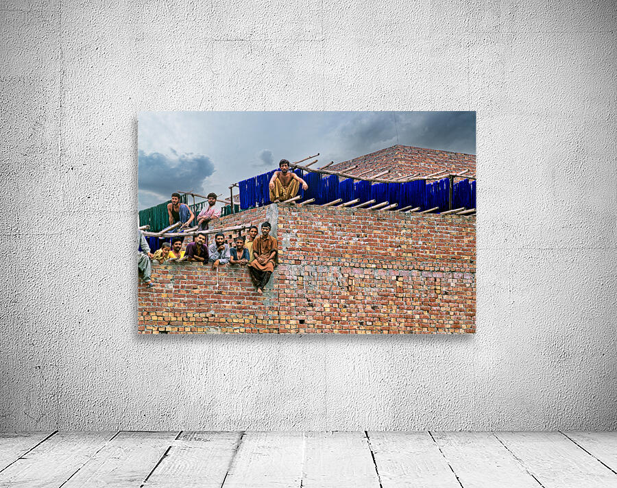Workers rest during break time at a construction site in Lahore Wall Preview