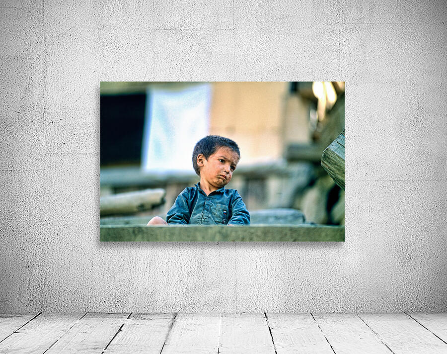 Sad boy sitting on stairs in Lahore Pakistan during the day Wall Preview