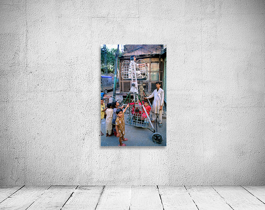 Children enjoy playtime on a swing in Lahore Wall Preview