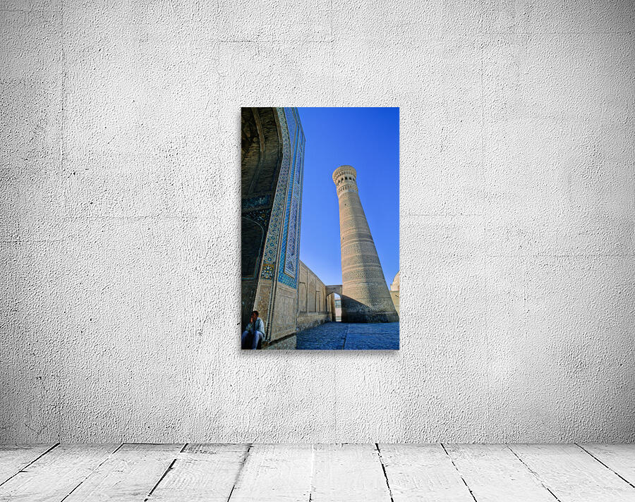 People rest near the tall minaret in Khiva Uzbekistan Wall Preview