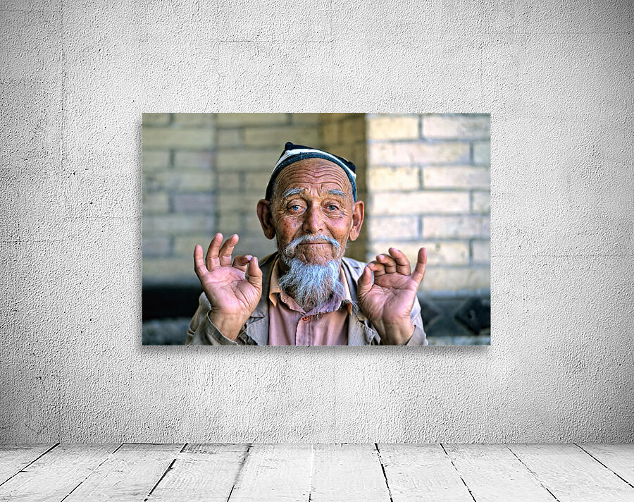 Elderly man showing hand gestures in Khiva Uzbekistan Wall Preview