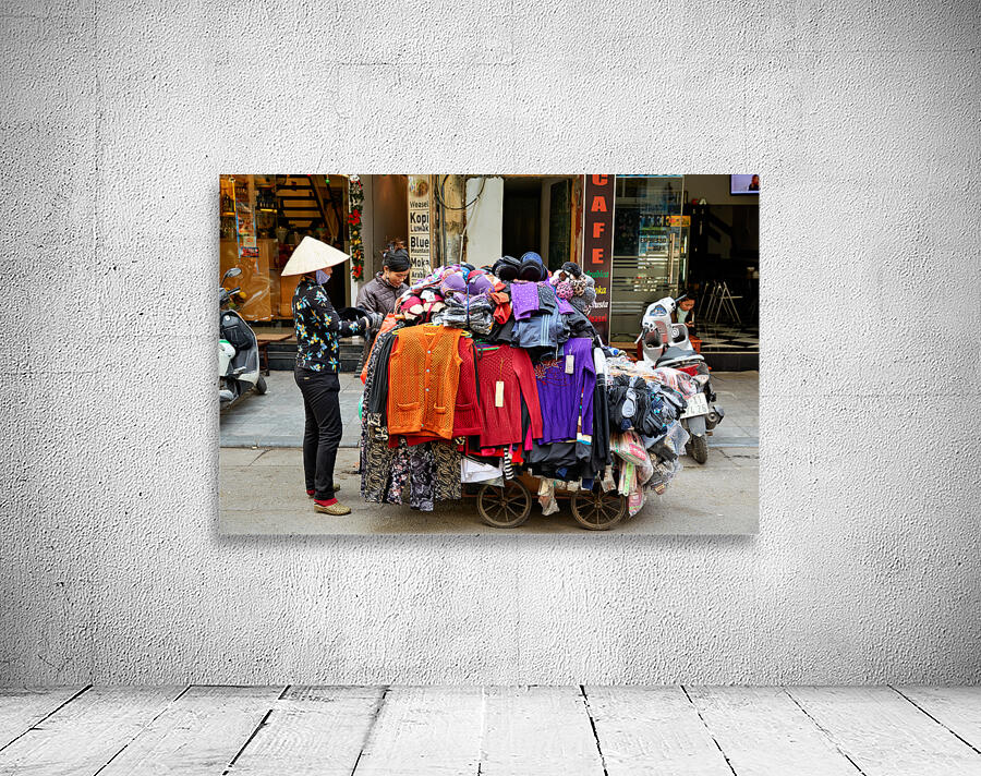 Market scene in Hanoi with a man selling clothes on a cart Wall Preview