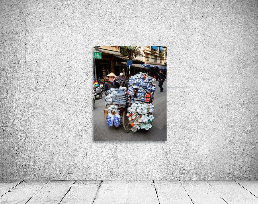 Woman transports pottery on a bicycle in Hanoi streets Wall Preview