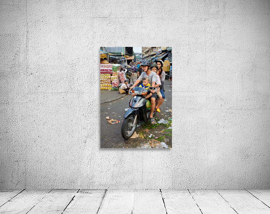 Motorbike family ride through busy Ho Chi Minh street in Vietnam Wall Preview