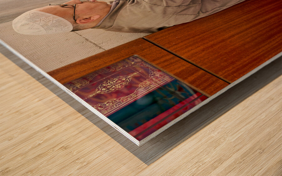 Istanbul Turkey. Muslim believer praying and reading Koran in the Fatih Mosque Wood print