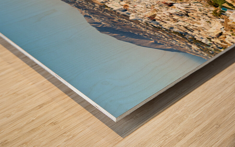 Santorinis white buildings on caldera cliffs above the sea. Wood print