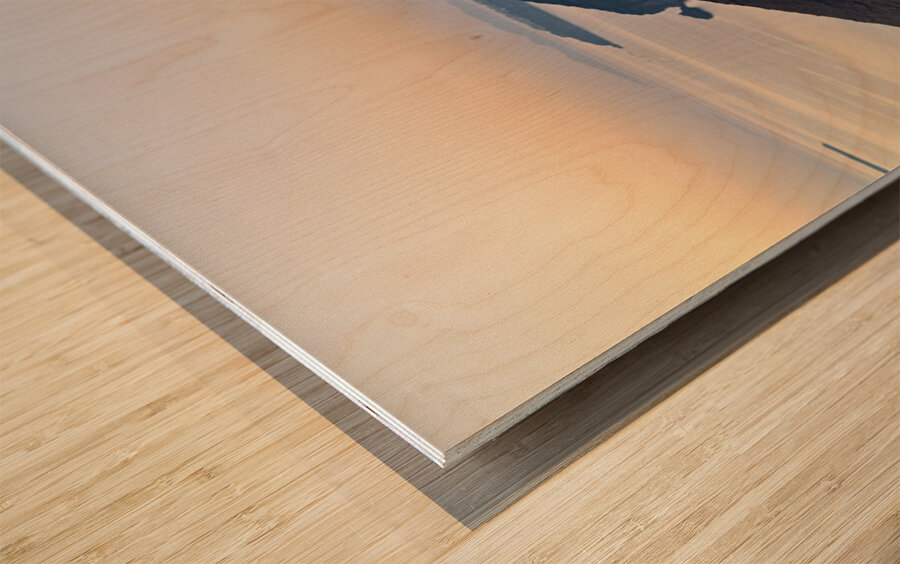 Santorini cliffside town with restaurants and people enjoying th Wood print