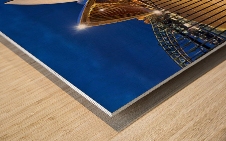 Sydney Opera House illuminated at dusk with crowds on steps. Wood print