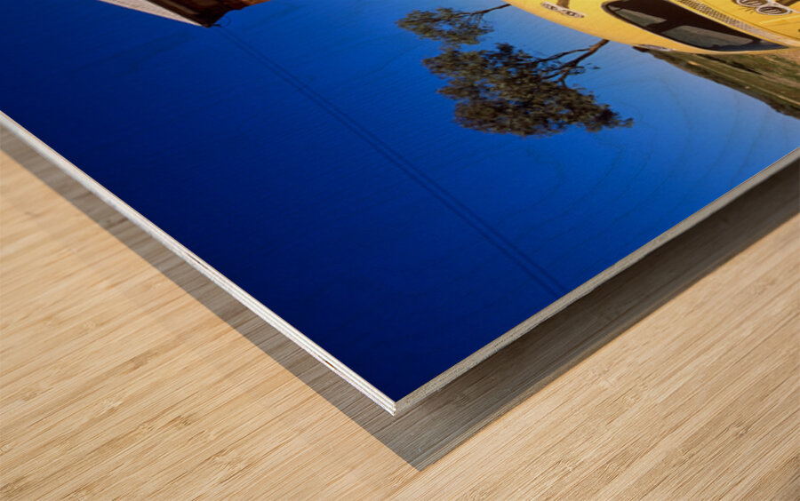 A painted yellow Beetle outside a rural stone gallery. Wood print