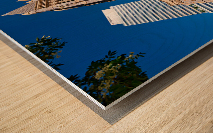 Historic church stands tall next to modern skyscrapers. Wood print