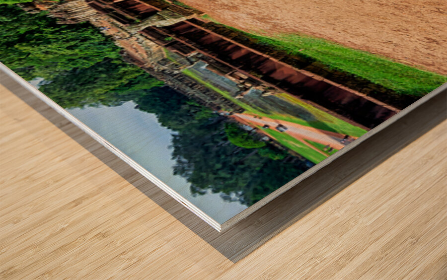 Ancient statue overlooks temple ruins amidst lush greenery. Wood print