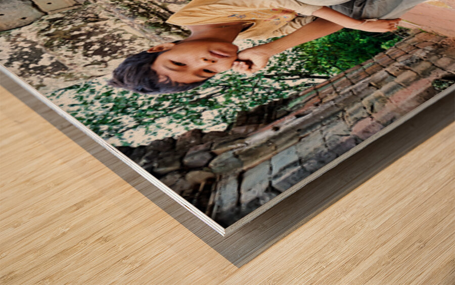 Young person sits on ancient temple ruins. Wood print